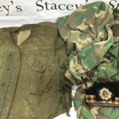 A collection of various military uniforms and fatigues. Shipping category D.