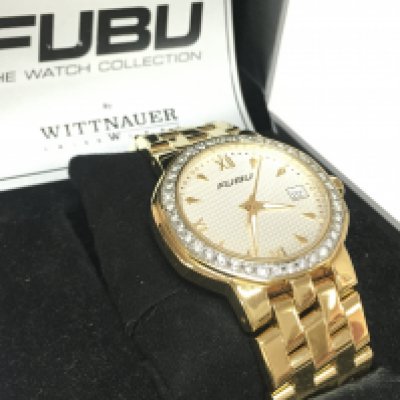 A boxed unworn clear stone set gold tone quartz watch by Wittnauer of Switzerland in collaboration with Fubu, working and complete with guarantee card. Postage category B