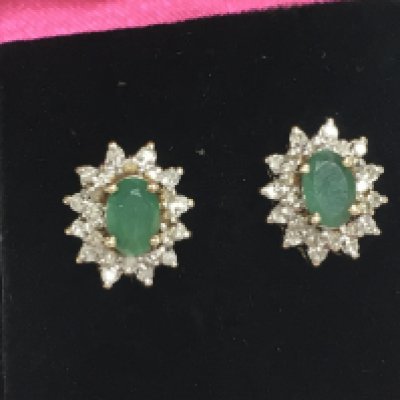 A pair of 9ct gold earrings set with diamonds and central emeralds, 2.38g total weight. Postage category A