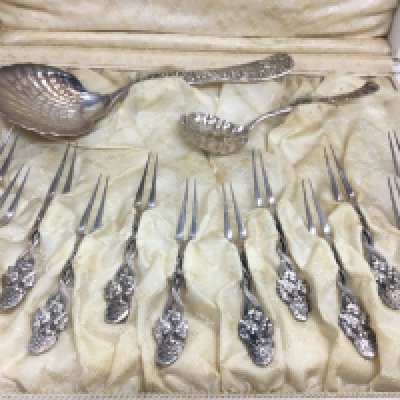 A cased Tiffany and Co sterling silver oyster set , postage category C