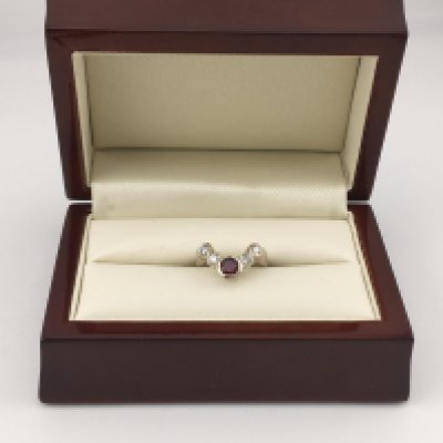 A 14ct white gold diamond and ruby wishbone style ring. Approx weight 3.75 grams, Approx size I1/2.