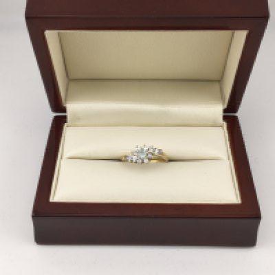 A yellow metal ring set with a blue stone and diamonds. Approx weight 2.81 grams, Approx size L.