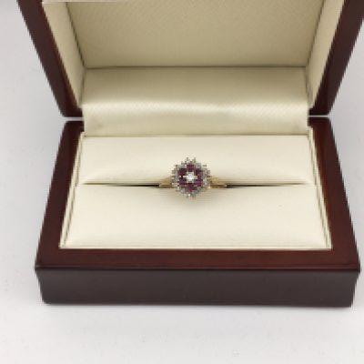 A 9ct diamond and ruby cluster ring. Approx weight 2.14 grams, Approx size N 1/2.