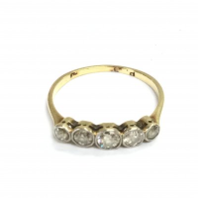 A 14k gold ring set with five old cut diamonds. 1.55g and size O Postage A