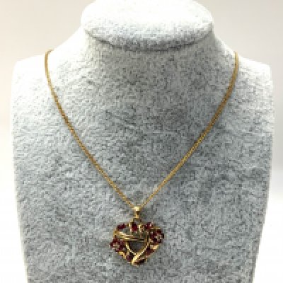 withdrawn A 9ct gold Ruby and diamond chip heart pendant and chain. (A)