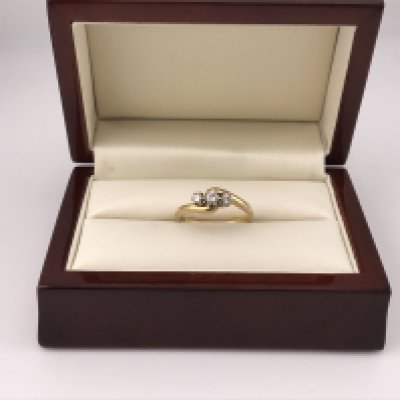 An 18ct three stone diamond ring. Approx weight 3.7grams, approx size N1/2.