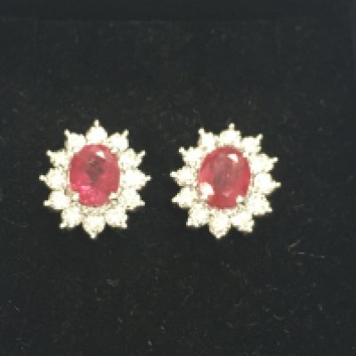 Pair of 18ct white gold oval ruby and diamond studs. Approximately 2.27ct rubies and 0.21ct diamonds. Postage B