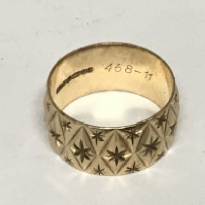 A wide and patterned 9carat gold wedding band weight 6.9g