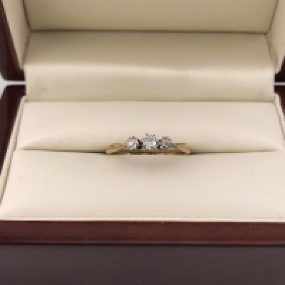 A three stone 18ct diamond ring. Approx weight 2.09 grams, approx size Q.