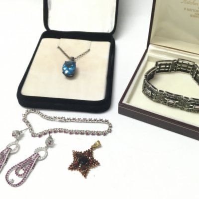 Silver and ruby earrings & matching bracelet, silver marcasite bracelet, silver red gemstone set star pendant, blue stone pendant with silver necklace. Postage category B