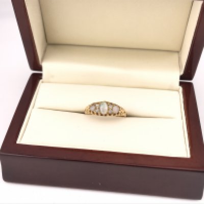 A yellow metal Opal set ring. Approx size N, approx weight 2.54 grams.