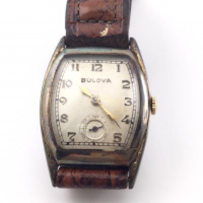 A vintage gents Bulova wrist watch on brown leather strap. Winds and runs. Postage B