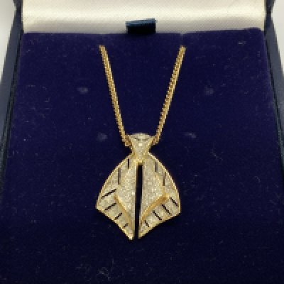 An art deco design 14ct yellow gold and diamond pendant and 10ct gold chain. (A) 7.3g total weight.