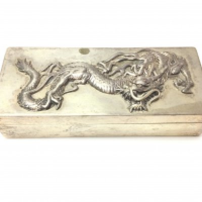 A silver Chinese box decorated with a raised dragon. 97g. 9.5cm wide by 4cm. Postage B
