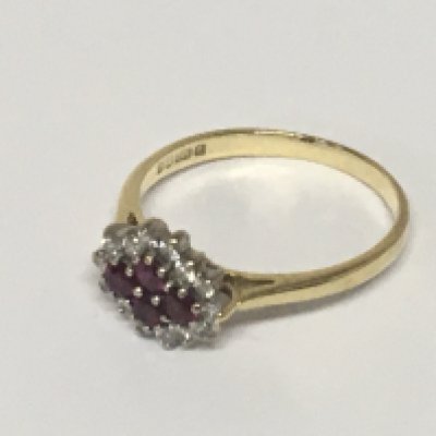 An 18carat gold ring set with a pattern of four ruby flanked by brilliant cut diamonds. Weight 3g ring size R.