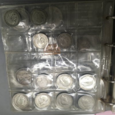 A box containing an album and loose coinage various