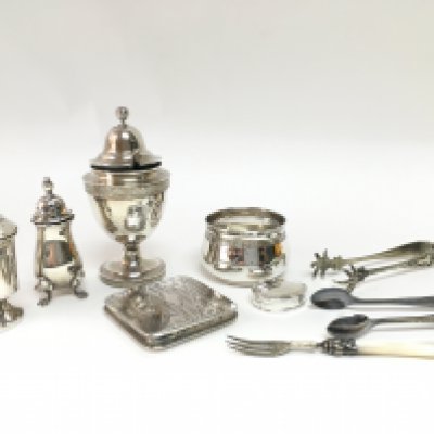 A collection of silver hallmarked items including a compact mirror, shakers, pill box, silver plated tongs etc. Postage category B