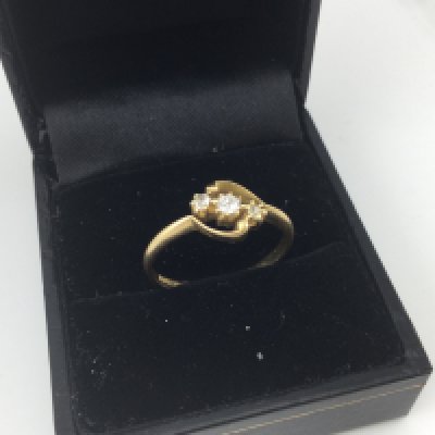 An 18ct gold diamond three stone ring. Approx weight 2.4 grams, size O.
