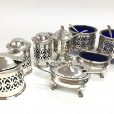 A collection of silver hallmarked cruet pieces including blue glass examples. This lot cannot be posted