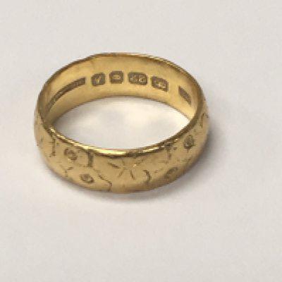 A 22 ct gold band ring 6.3 grams.