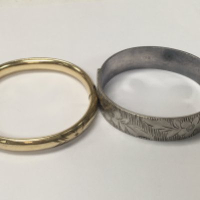 A silver bangle and gold plated bangle.