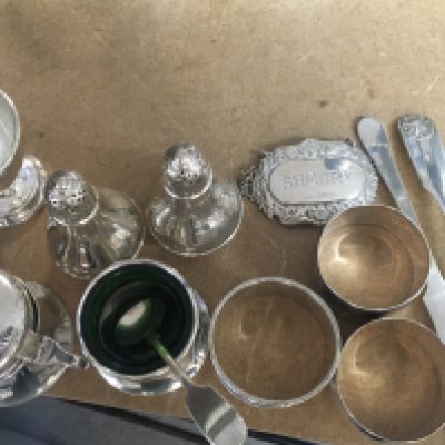 A Collection of silver including cruet&rsquo;s napkins rings spoons and wine label .