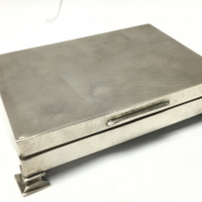 A Silver cigarette case , postage category B