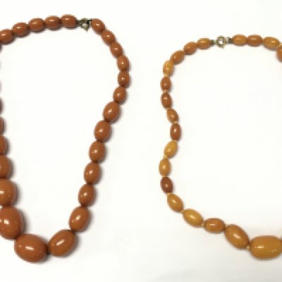 Two amber necklaces . Postage category A