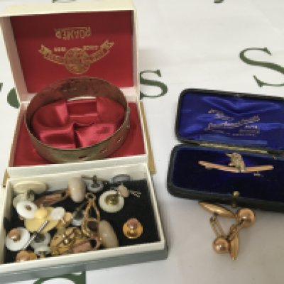 Apair of unmarked cufflinks a gold brooch with a bird set with seed pearl a silver bangle and a quantity of gents cufflinks in a box