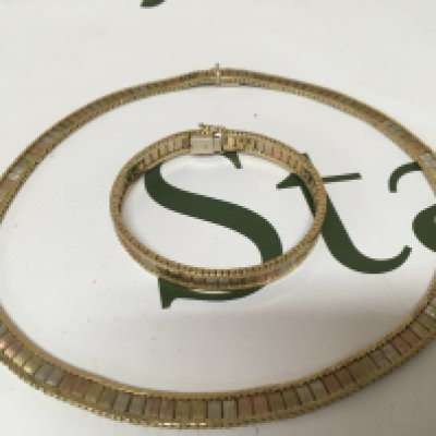 A gold necklace and matching bracelet the centre enclosed links with alternating three tone colour links both bracelet and necklace marked 9carat. Total weight 57g approximately.
