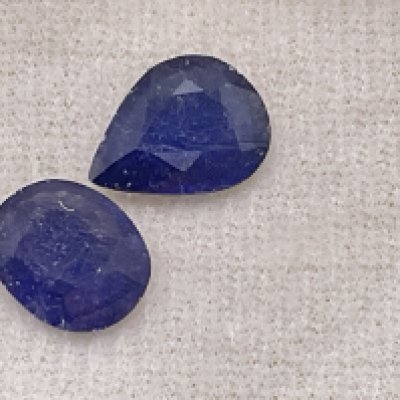 2 loose boxed sapphires (glass filled). Pear 2.92ct. Oval 2.74ct. Postage category A.