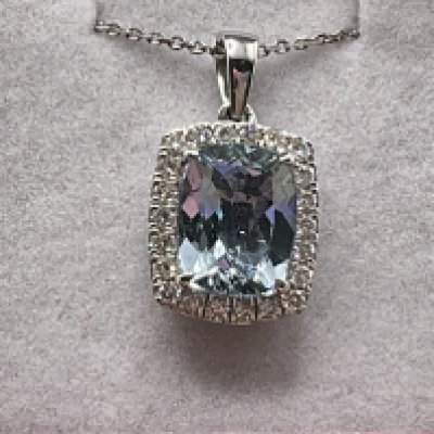 9ct white gold cushion cut aquamarine and RBC diamond cluster pendant on a 9ct white gold chain, boxed. Aquamarine 1.92ct. Diamonds 0.26ct. Postage category A.