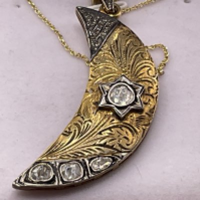 Unusual silver gilt crescent moon shaped pendant set with slice diamonds and mixed cut diamonds on a gold plated silver chain, boxed. Diamonds 0.83ct. Postage category A.