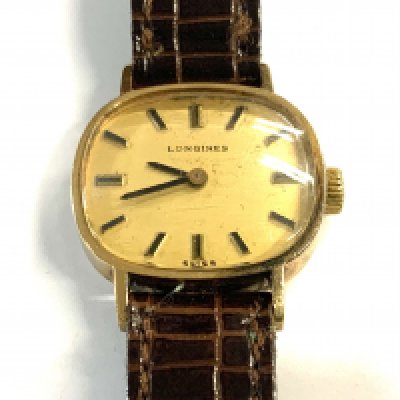 A ladies 9ct gold cased longines wristwatch with crocodile skiing strap.