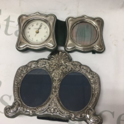 A silver double photo frame together with a silver desk clock and photo frame.