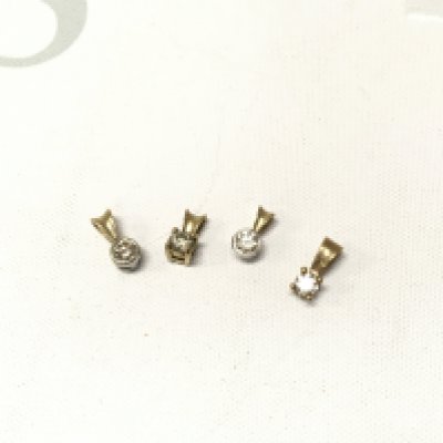 Four 9ct gold diamond solitaire pendants. Approx weight 1.9grams.