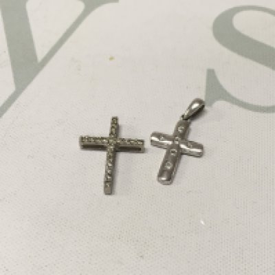 Two platinum diamond set crosses. Approx weight 2.5 grams.