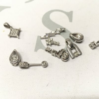 An assortment of 9ct white gold diamond set pendants. Approx weight 6.9grams.