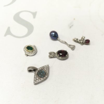 A mixed assortment of unmarked white metal stone set pendants. Approx weight 7.0 grams.
