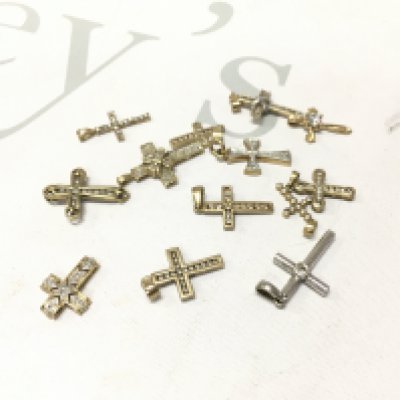 A mixed assortment of 9ct gold stone set crosses including two 14ct examples. Approx weight 20.1 grams.