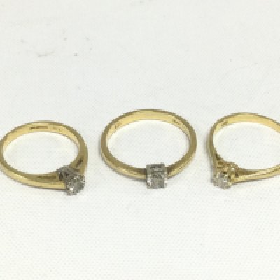 Three 18ct gold diamond solitaire rings, approx total weight 6.4g and approx sizes K, H and M. Shipping category A.