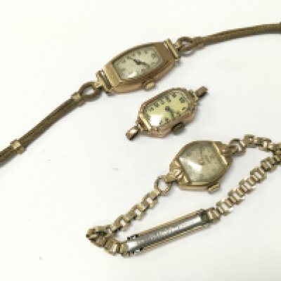 Three 9ct gold cased ladies watches with stainless steel and rolled gold straps . 29.8g total weight. Postage category A