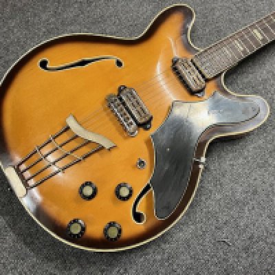 A 1964 Vox Lynx electric guitar. Semi sold thinline type with rosewood type board and block markers. This guitar comes with the rarer batwing pick guard and toaster style pickups. Being a circa 1964 guitar it was made in Italy at the Crucianella factory. Condition wise good considering age and use and has tarnishing to brightwork and some crazing in the lacquer which has aged to a nice patina. Comes with cardboard case.