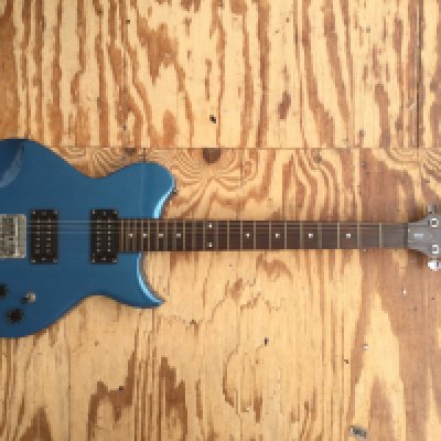 A Washburn WI24 electric guitar and gig bag.