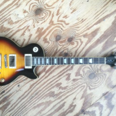 An Epiphone by Gibson Les Paul 1960 Tribute Plus electric guitar. Comes with a soft carry case.