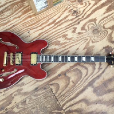 A Benson 335 style electric guitar, no case.