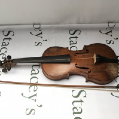 A violin and bow. Maker's name to inside of sound hole almost illegible, please see images. Make of bow is Leon Bernardel, Paris. No case.