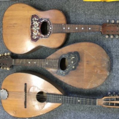 A small collection of mandolins and a ukulele.