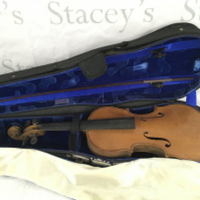 A cased violin and bow. The label inside the soundhole indicating it was manufactured on the Isle Of Wight.