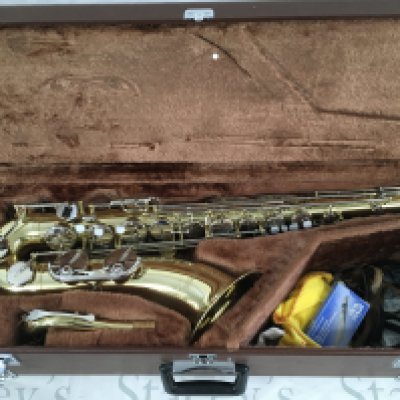 A cased Yamaha saxophone with accessories.